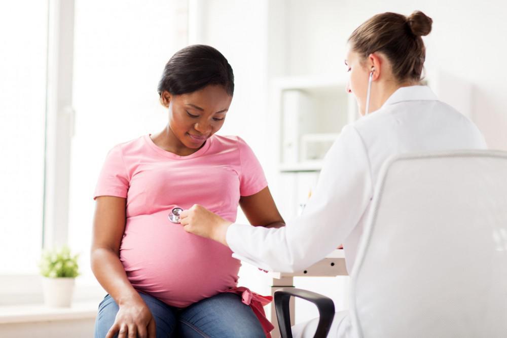 Pregnant patient being seen by doctor