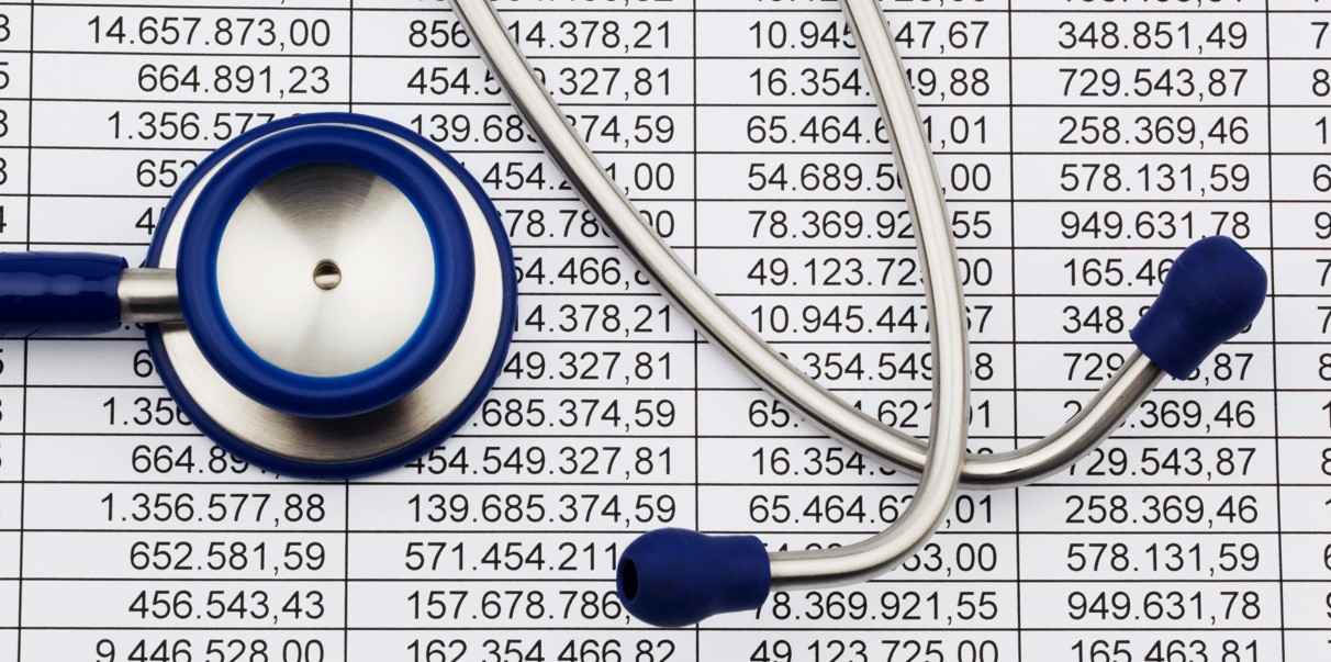 Balance sheet figures and stethoscope